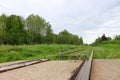 View from railroad crossing to abandoned rail track overgrown with grass in Russia Royalty Free Stock Photo