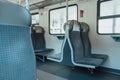 View on railroad track from the window of fast train. Interior view at train's empty window seat window move through Royalty Free Stock Photo