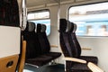 View on railroad track from the window of fast train. Interior view at train's empty window seat window move through Royalty Free Stock Photo