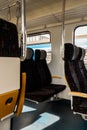 View on railroad track from the window of fast train. Interior view at train's empty window seat window move through Royalty Free Stock Photo