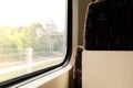 View on railroad track from the window of fast train. Interior view at train's empty window seat window move through Royalty Free Stock Photo