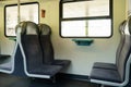 View on railroad track from the window of fast train. Interior view at train's empty window seat window move through Royalty Free Stock Photo