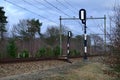 View of rails and signal posts from beside a train track in the Netherlands Royalty Free Stock Photo