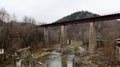 View of the railway bridge over the Prut river. A small town or village of Yaremche among the Carpathians on an autumn afternoon Royalty Free Stock Photo