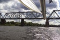 View of the railway bridge from the yacht. Part of the boom of the yacht. Storm clouds in the sky Royalty Free Stock Photo