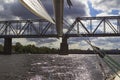 View of the railway bridge from the yacht. Part of the boom of the yacht. Storm clouds in the sky Royalty Free Stock Photo