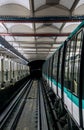 A view from the railway tracks of a Paris metro train at a station with a historic vaulted ceiling and automatic security access Royalty Free Stock Photo
