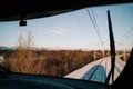 View of the railway of the train covered with snow surrounded by trees and the landscape of snowy mountains in a sunny day. Royalty Free Stock Photo