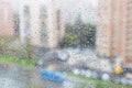 View of raindrops on windowpane of urban house