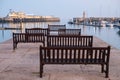 View of Ramsgate Royal Harbour, Ramsgate, Kent UK, taken in the early evening light with benches laid out of the jetty.