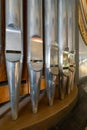 Portrait view of a rank of shining steel pipes of a refurbished church organ Royalty Free Stock Photo