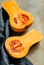 View on raw halves of butternut squash on a kitchen table