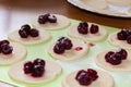 View on raw uncooked semi-finished sweet vareniki dumplings, with cherry