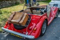 The rear of a red hand built Morgan sports car parked up in a Norfolk village