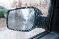 View of the rear view mirror on a rainy day from inside the car Royalty Free Stock Photo