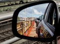 View through the rearview mirror of cars on the upper deck of a car train Royalty Free Stock Photo