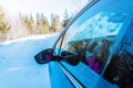 View of the rearview mirror of a moving car on a snowy, winter surface Royalty Free Stock Photo