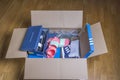 View of received home delivery box with fashionable, sports, various shoes.