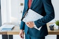 View of recruiter standing and holding clipboard with resume letters