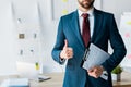 View of recruiter standing and holding clipboard with resume letters while showing thumb up