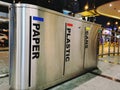 View of recyclable bin next to bust stop station.A recycling bin is used to hold recyclables before taken to recycle centre