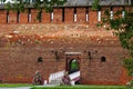 View on red brick wall with loopholes and gate to Kolomna Kremlin decorated with flowers. Monument, Russian history, sightseeing,