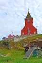 View of the church and traditional Greenland sledges in the foreground in Sisimiut