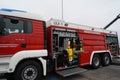 View on red fire-brigade truck with open side door where is visible firefighting equipment. Royalty Free Stock Photo