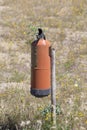 Red fire extinguisher in the field