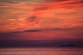 view of red fleecy clouds before sunrise sea on foreground Royalty Free Stock Photo