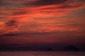 view of red fleecy clouds before sunrise sea on foreground Royalty Free Stock Photo