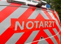 View on red german emergency ambulance with lettering notarzt focus left