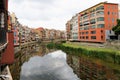 View of red houses and their reflection in a canal in Girona, Spain. Royalty Free Stock Photo