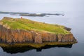 view of the red lighthouse on the cliff in the harbour of Stykkisholmur Royalty Free Stock Photo