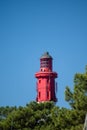 View on red lighthouse Le Phare du Cap Ferret, Arcachon Bay with many fisherman\'s boats and oysters farms near , Cap Ferret