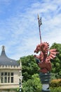 medieval dragon statue with spear, shield and flag