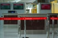 View of red queue retractable belt barrier with Emirates Airlines logo at departure gate in Dubai International Airport terminal Royalty Free Stock Photo