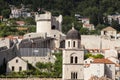 View of the red tile roofs, a tower and part of the stone wall, from a street in the upper part of the city, in Dubrovnik, Croatia