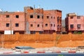 View of the red walls unfinished residential buildings in Marrakech on a sunny day. Morocco