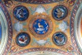 View of religious frescoes decorating ceiling inside catholic church in Italy