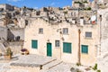 View of a residential area with a home featuring green doors in the ancient cave city of Matera, Italy, an Unesco World Heritage Royalty Free Stock Photo