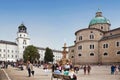 View of the Residenzplatz, the Residenzbrunnen fountain, the new residence of the Archbishop and numerous tourists. Salzburg Royalty Free Stock Photo
