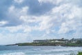 View of resort buildings on tropical island against cloudy sky Royalty Free Stock Photo