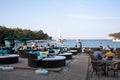 View of restaurant or cafe in Moon Light park in Kemer, Turkey. People on the beach. Tables and chairs near sea harbor Royalty Free Stock Photo