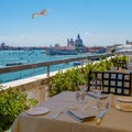 View from the restaurant on the cityscape of Venice and Grand Canal with Santa Maria della Salute church. Royalty Free Stock Photo