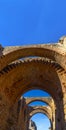 View of the restored arches of the halls of the archaeological complex of Merida towards the Roman Amphitheater of MÃÂ©rida Royalty Free Stock Photo