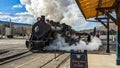 View of a Restored Narrow Gauge Steam Locomotive Blowing Smoke and Steam on a Winters Day