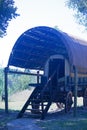 VIEW OF A RESTORED PIONEER OX WAGON UNDER COVER