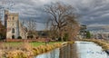 View of the restored Stroudwater Canal as it passes the Church of St Cyr near Stroud Gloucestershire, UK