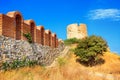 View of the restored wall of the basilica church of the Holy Mother of God Eleusa and windmill ruins in the Old Town of Nessebar